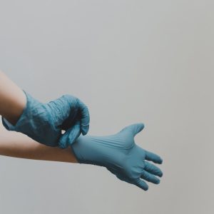 person in blue gloves and blue denim jeans